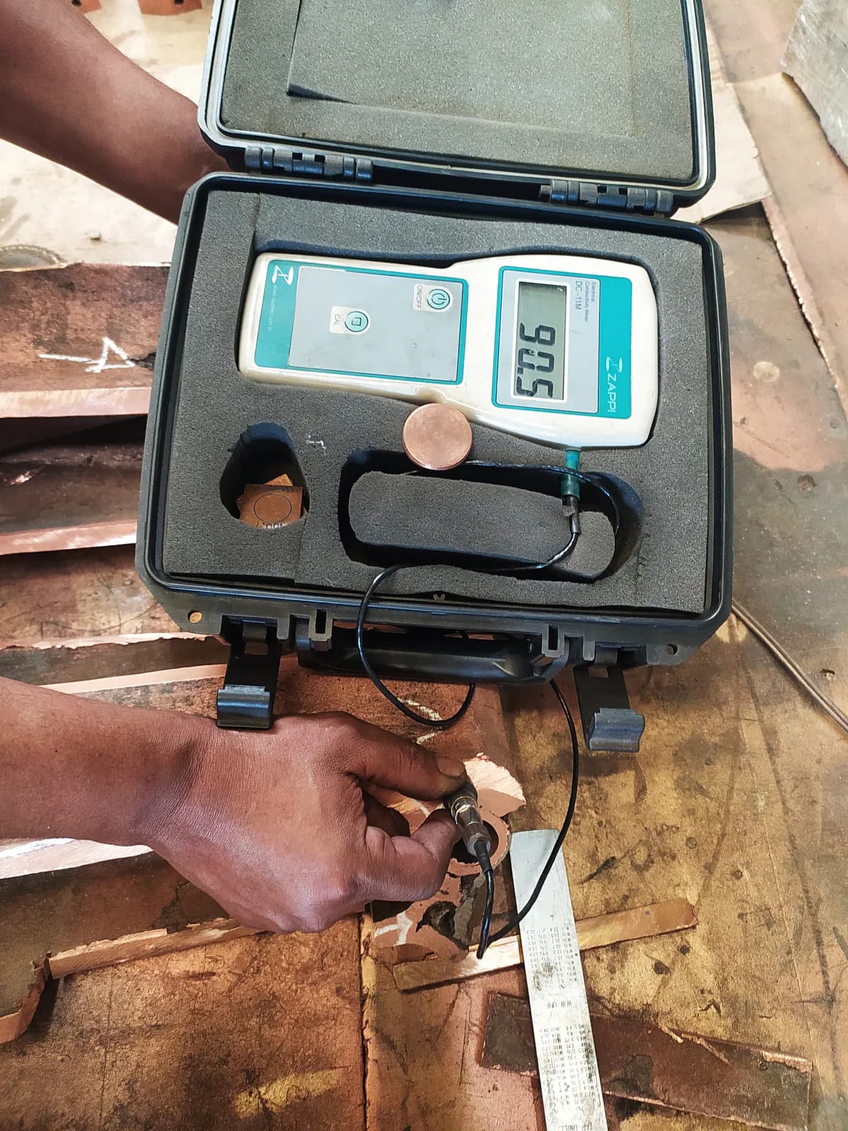 Electrical conductivity test on a copper sample using a conductivity meter